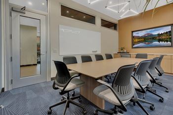 Conference room with whiteboard and wooden table